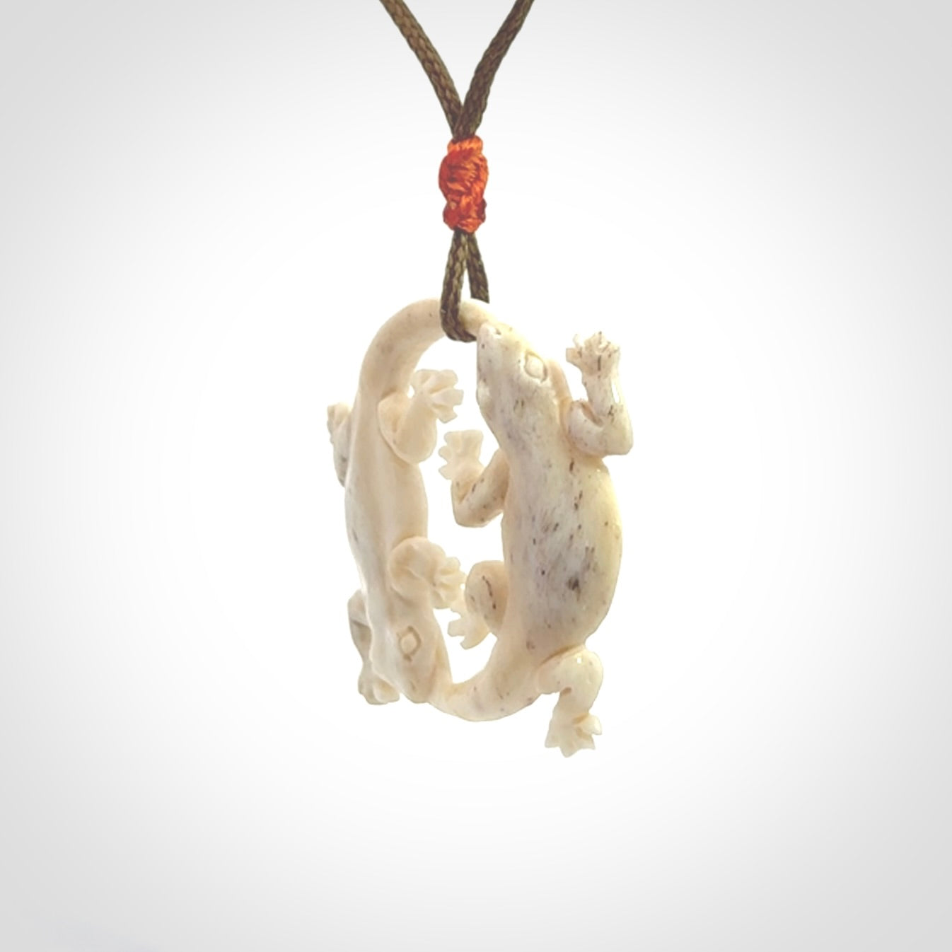 Hand carved bone double lizard pendant.