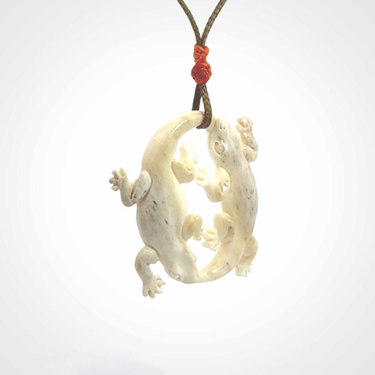 Hand carved bone double lizard pendant.