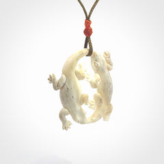 Hand carved bone double lizard pendant.