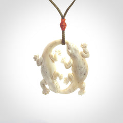 Hand carved bone double lizard pendant.