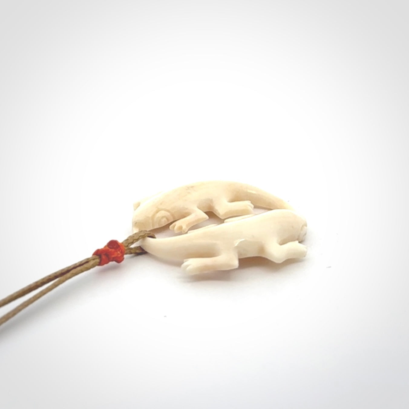 Hand carved bone double lizard pendant.