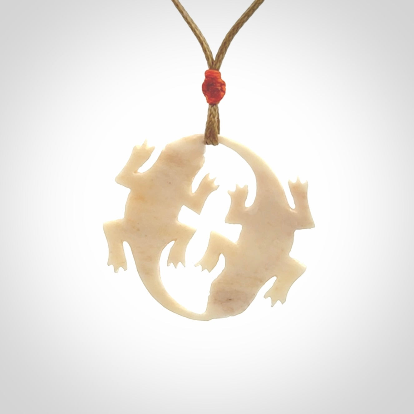Hand carved bone double lizard pendant.