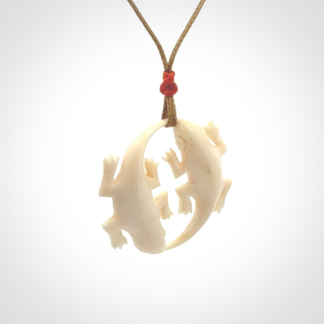 Hand carved bone double lizard pendant.