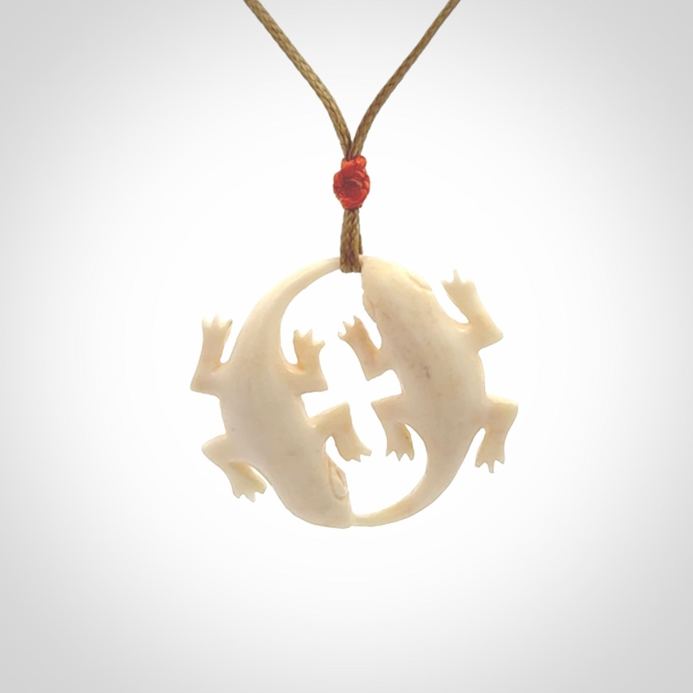 Hand carved bone double lizard pendant.