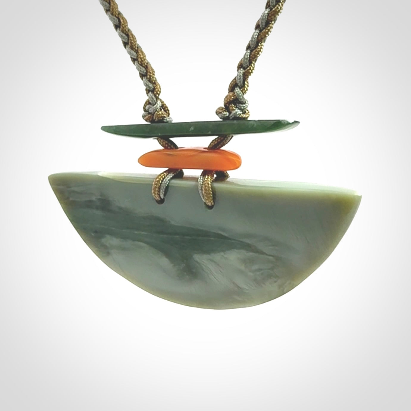Hand carved New Zealand Jade half shield pendant with adjustable cord. Free shipping worldwide.
