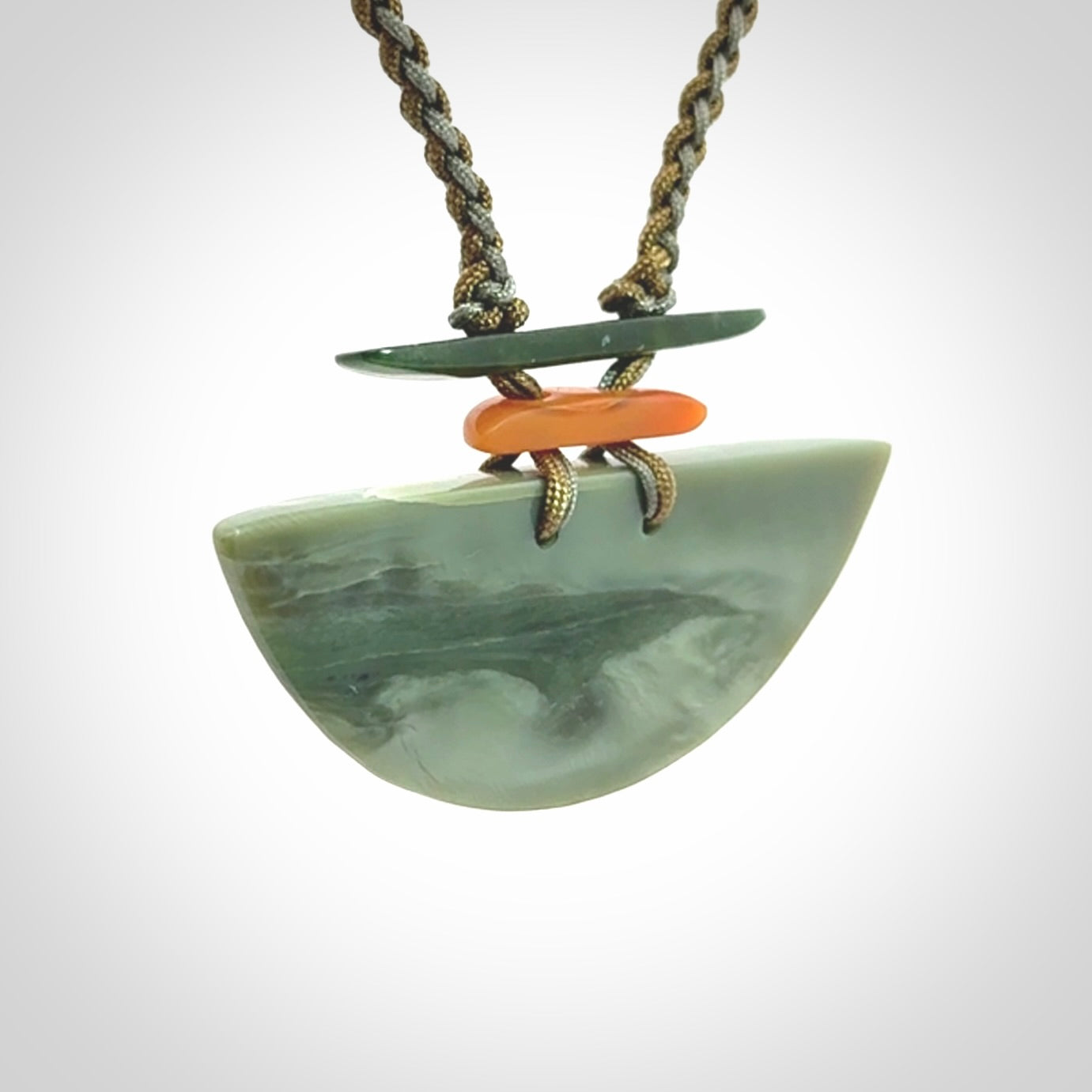 Hand carved New Zealand Jade half shield pendant with adjustable cord. Free shipping worldwide.