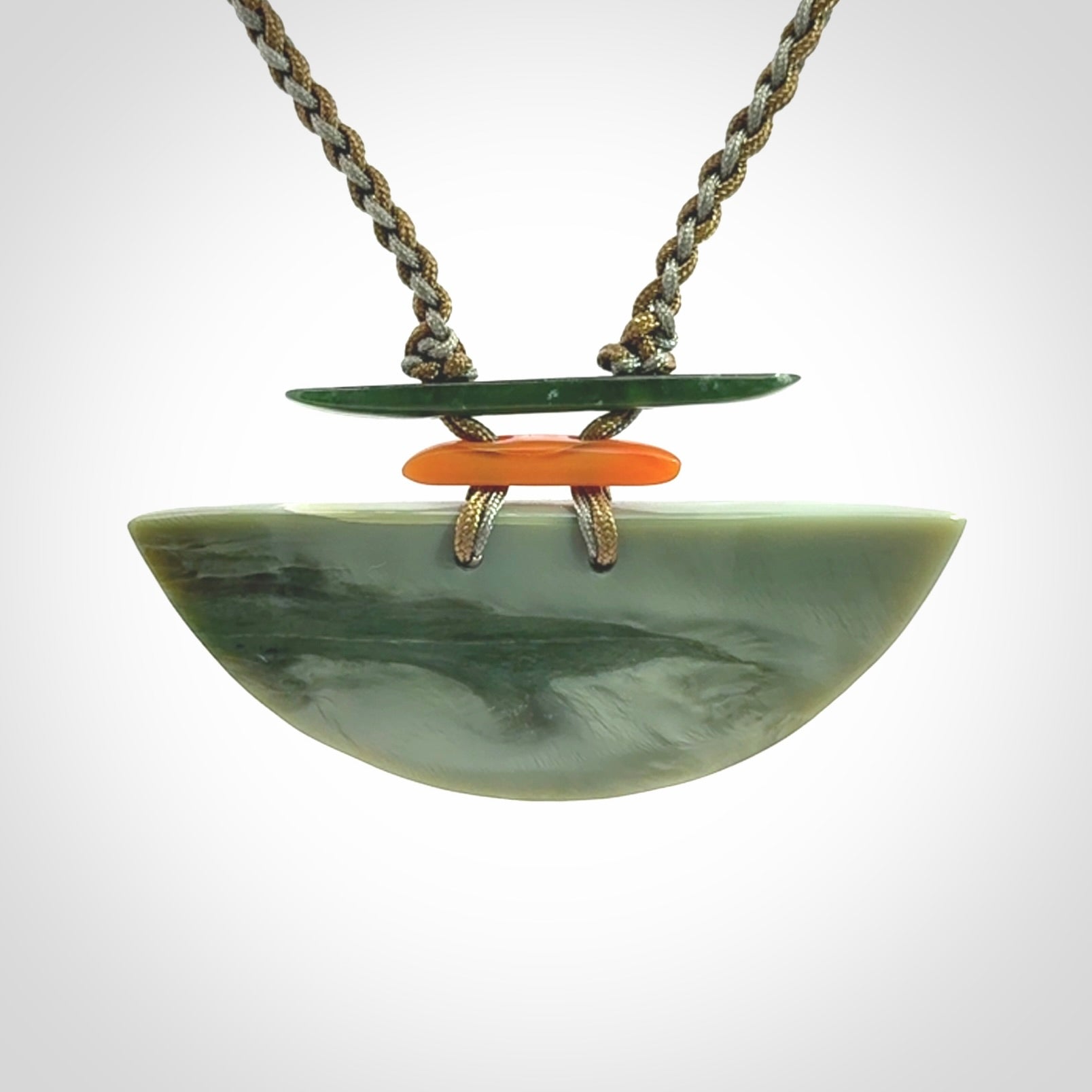 Hand carved New Zealand Jade half shield pendant with adjustable cord. Free shipping worldwide.