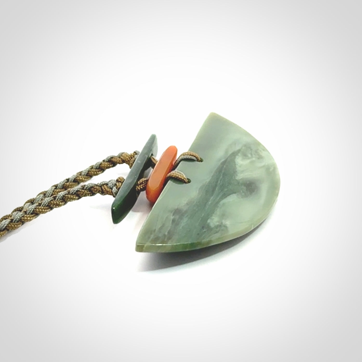 Hand carved New Zealand Jade half shield pendant with adjustable cord. Free shipping worldwide.