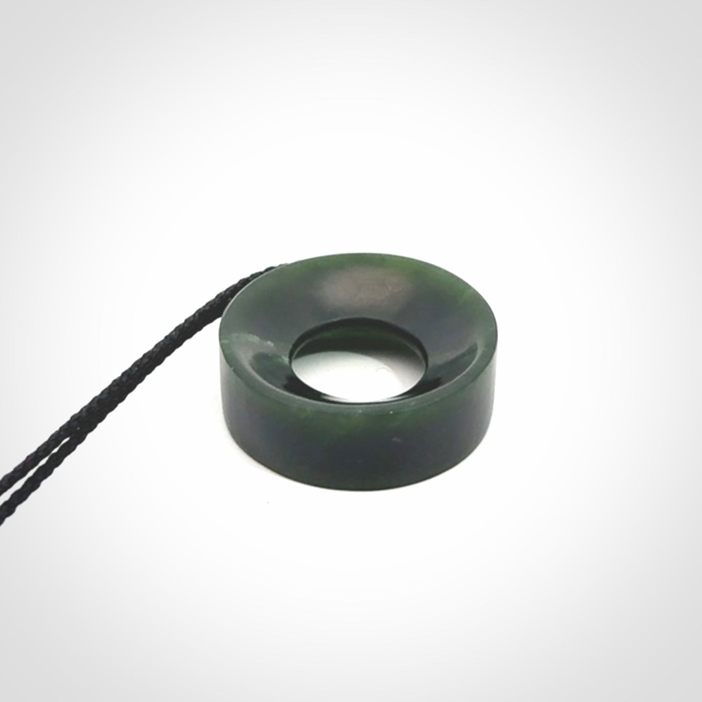 Hand carved contemporary pendant from a lovely dark piece of New Zealand Jade.