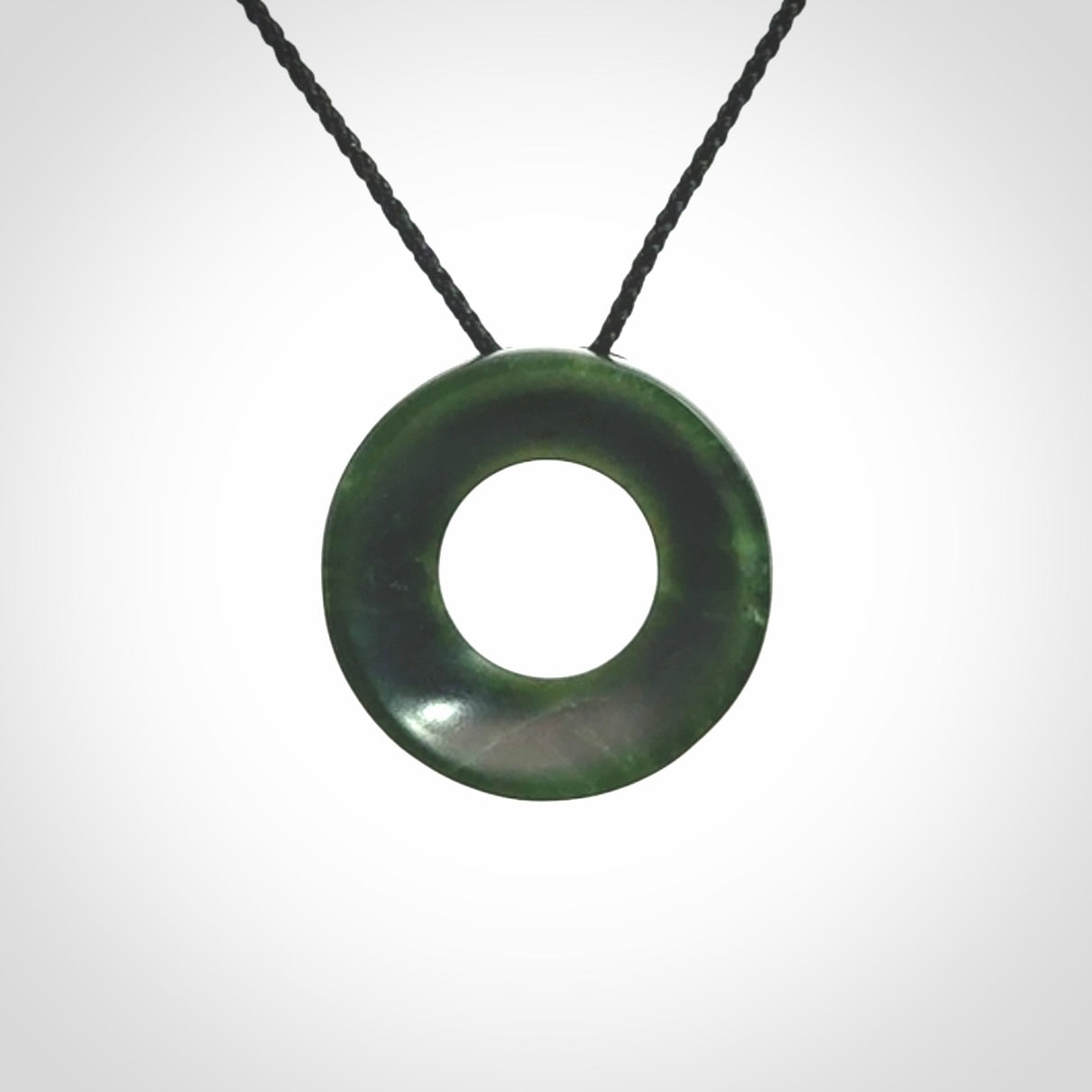 Hand carved contemporary pendant from a lovely dark piece of New Zealand Jade.