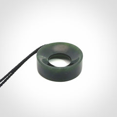Hand carved contemporary pendant from a lovely dark piece of New Zealand Jade.