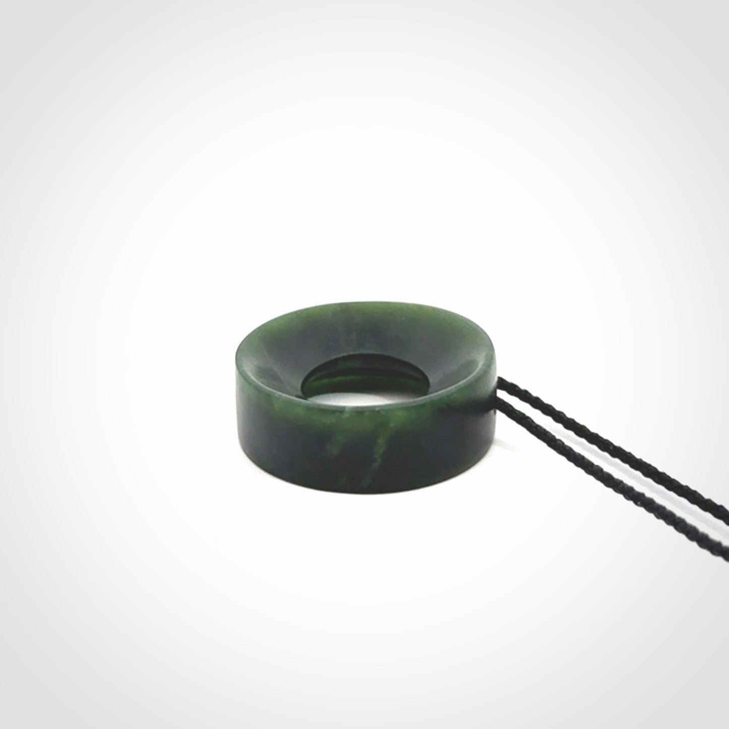 Hand carved contemporary pendant from a lovely dark piece of New Zealand Jade.