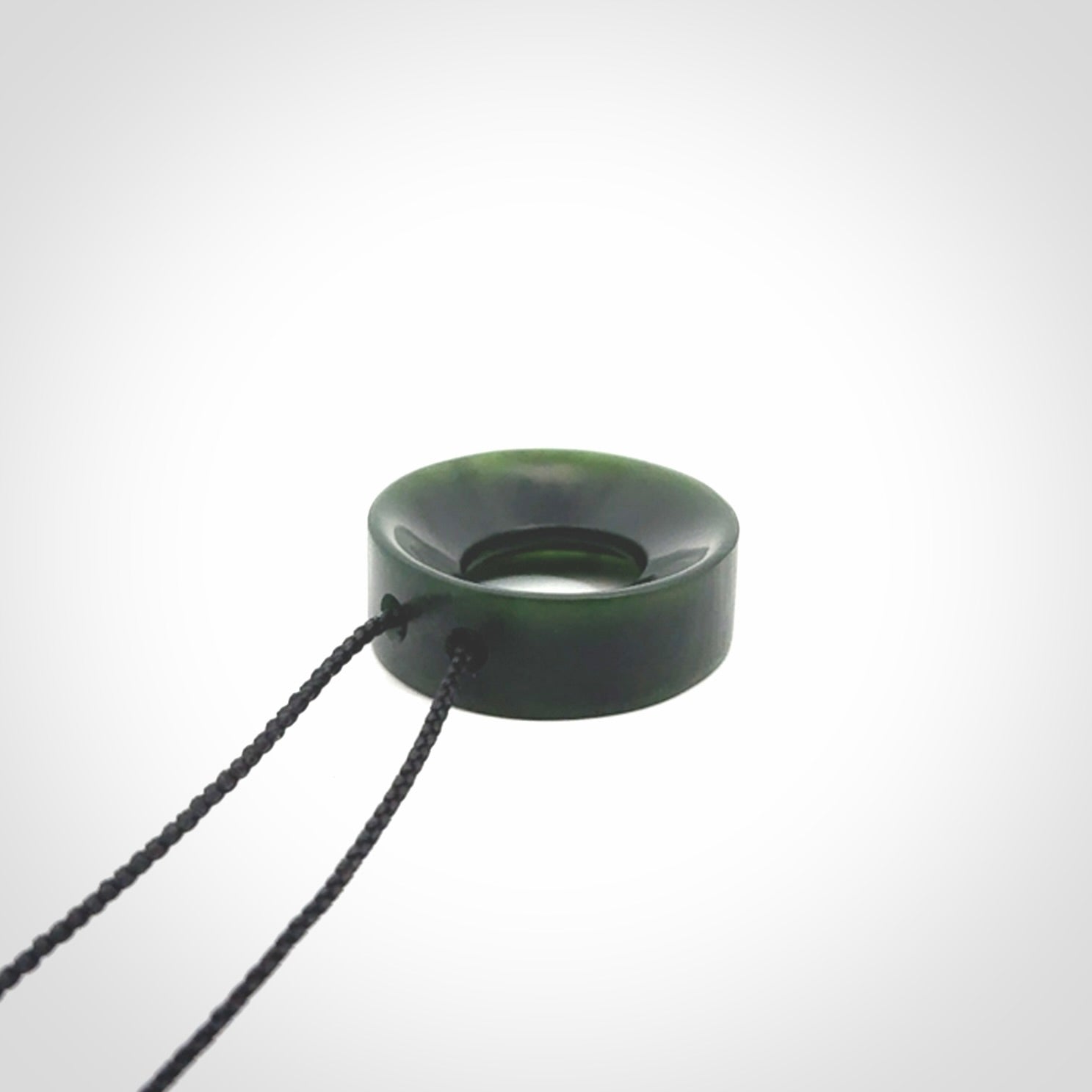 Hand carved contemporary pendant from a lovely dark piece of New Zealand Jade.