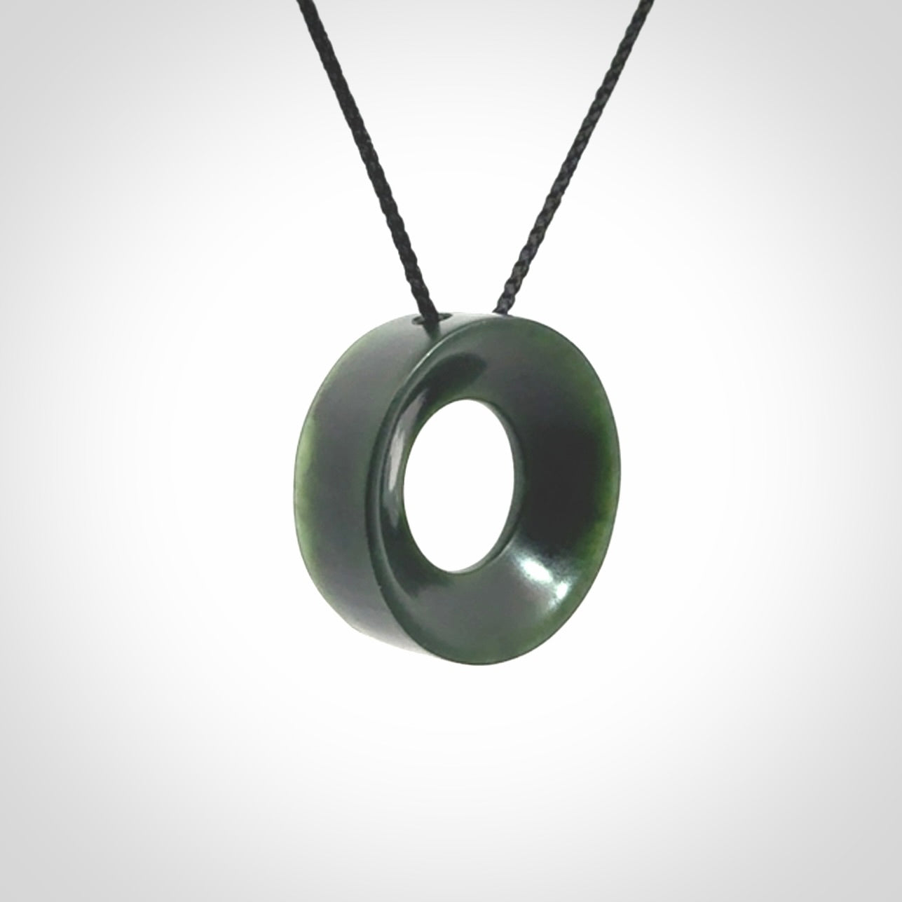 Hand carved contemporary pendant from a lovely dark piece of New Zealand Jade.