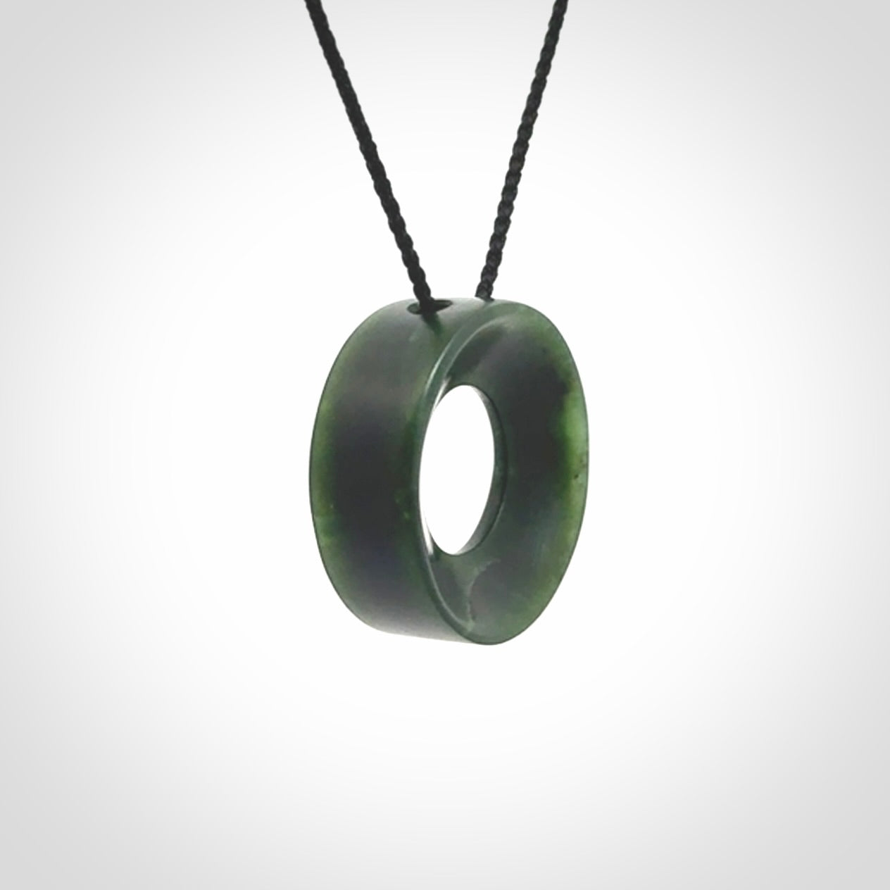 Hand carved contemporary pendant from a lovely dark piece of New Zealand Jade.