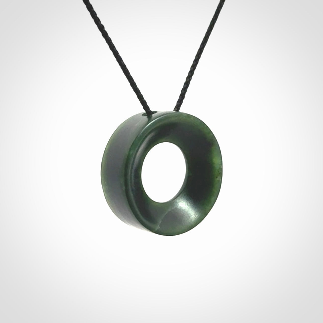 Hand carved contemporary pendant from a lovely dark piece of New Zealand Jade.