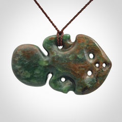 This is a large sized tiki - carved from gorgeous Marsden jade with Pāua Shell eyes. The craftsmanship is superb, this piece is as well carved as any we have seen. We have plaited an adjustable brown cord for this piece.&nbsp;