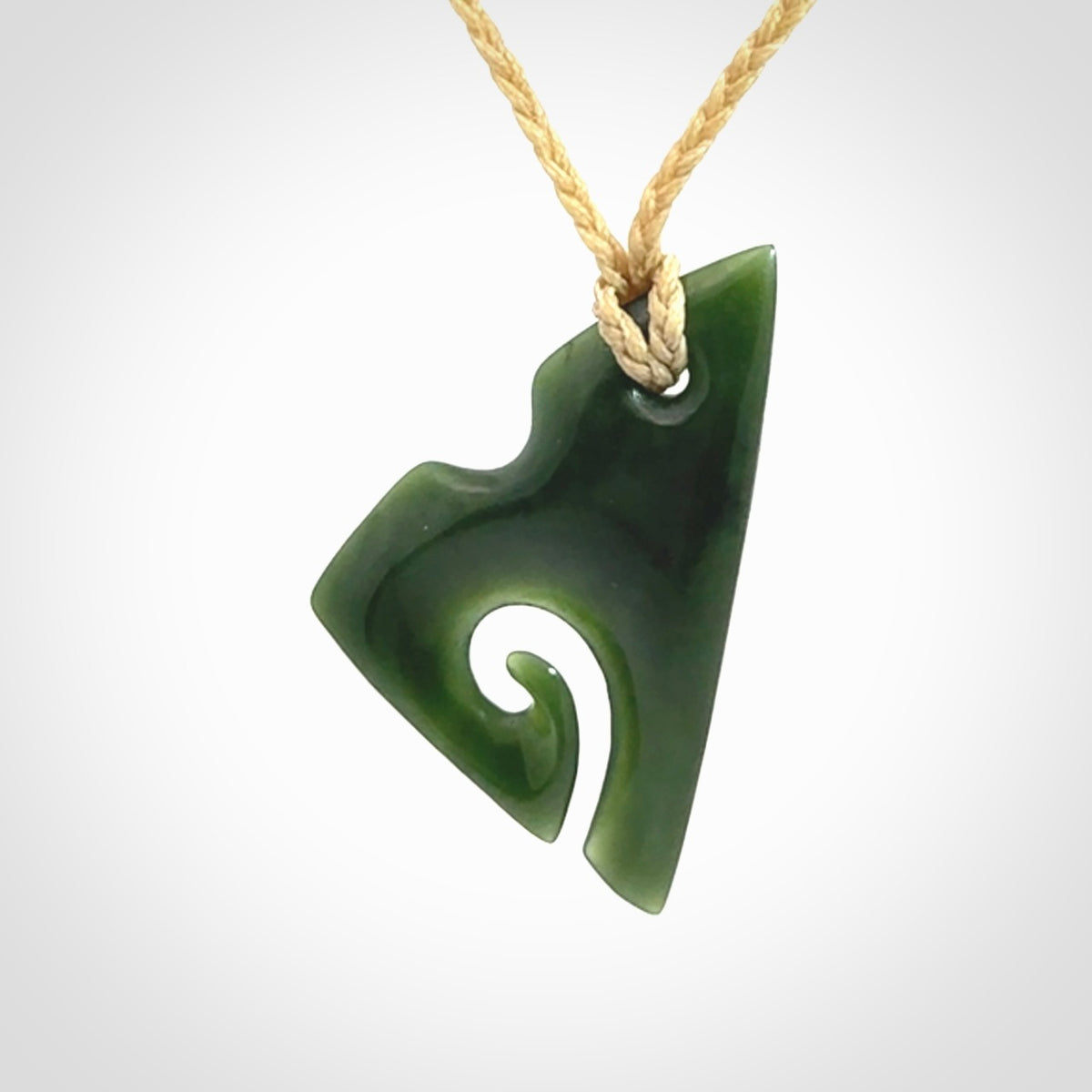 This photo shows a koru pendant carved from New Zealand Jade. We provide this piece with an adjustable oat cord.