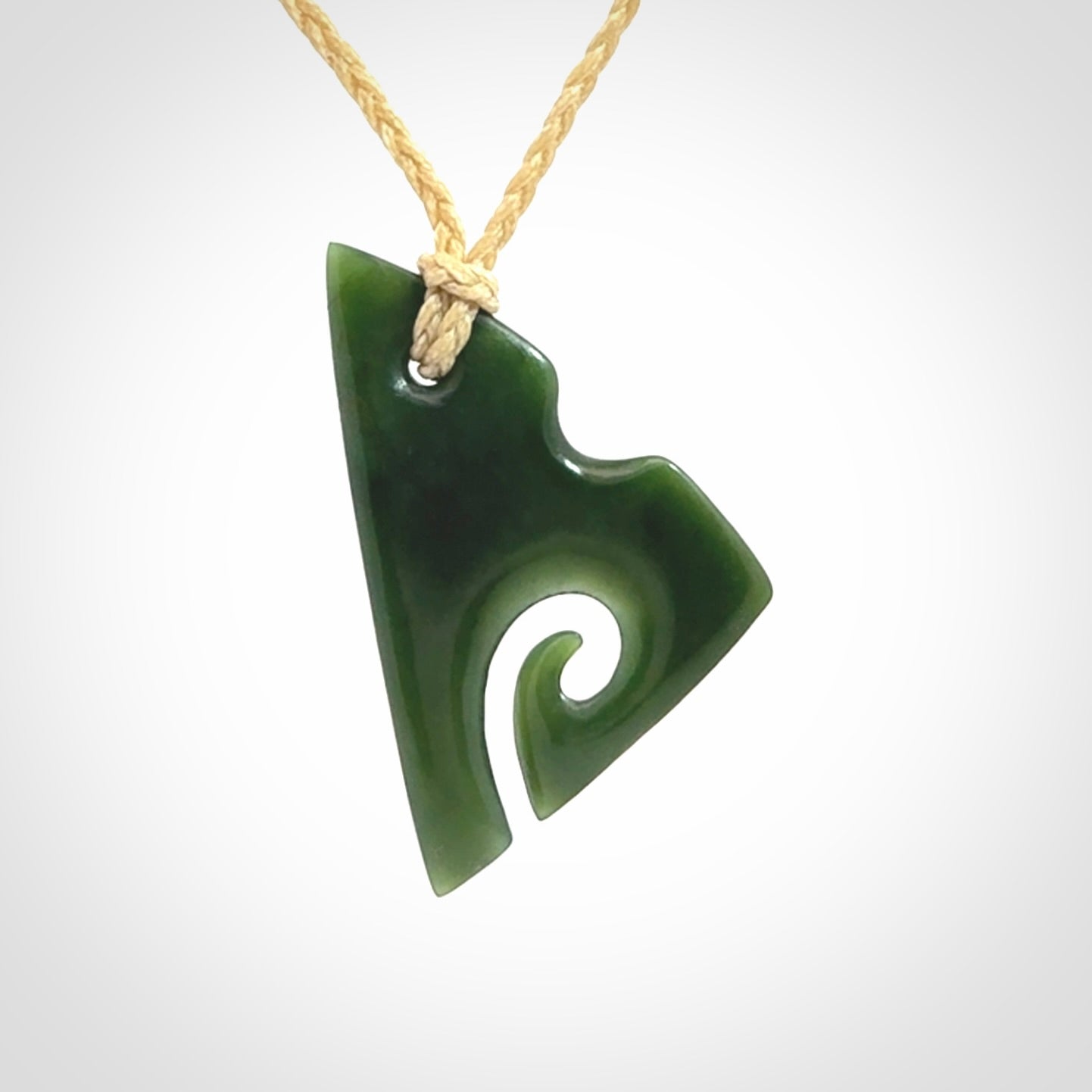 This photo shows a koru pendant carved from New Zealand Jade. We provide this piece with an adjustable oat cord.