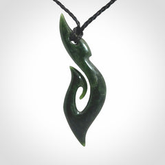 This photo shows a large hook with koru pendant carved from New Zealand Jade. The artist, Shaun Gardiner, has carved this beautifully. We provide this piece with an adjustable black cord. This is a fantastic work of art, we have one only.