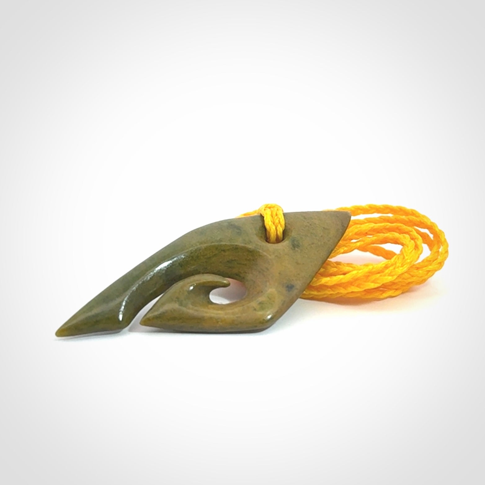 This photo shows a contemporary koru pendant carved into New Zealand Flower Jade. We have added a yellow adjustable cord. This is a fantastic work of art, we have one only.