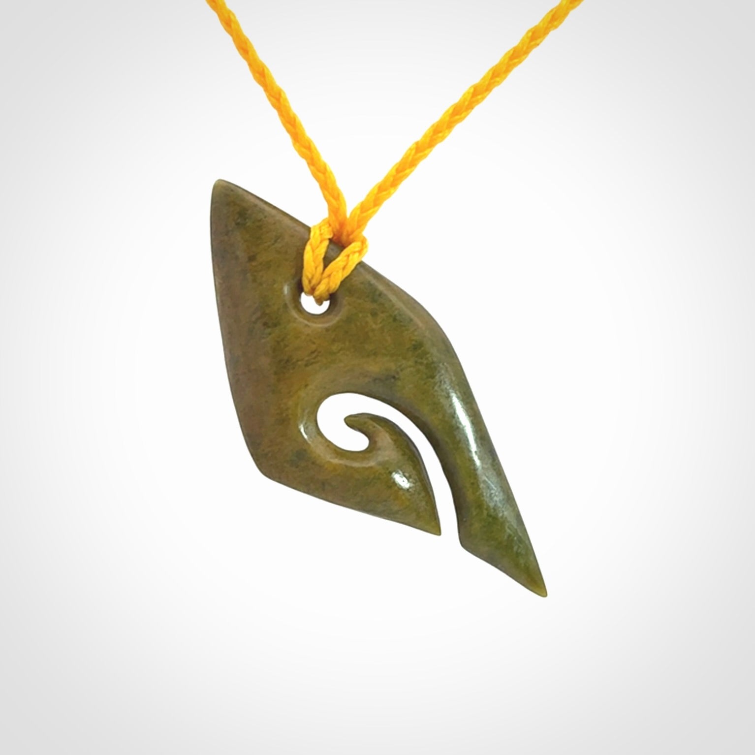 This photo shows a contemporary koru pendant carved into New Zealand Flower Jade. We have added a yellow adjustable cord. This is a fantastic work of art, we have one only.