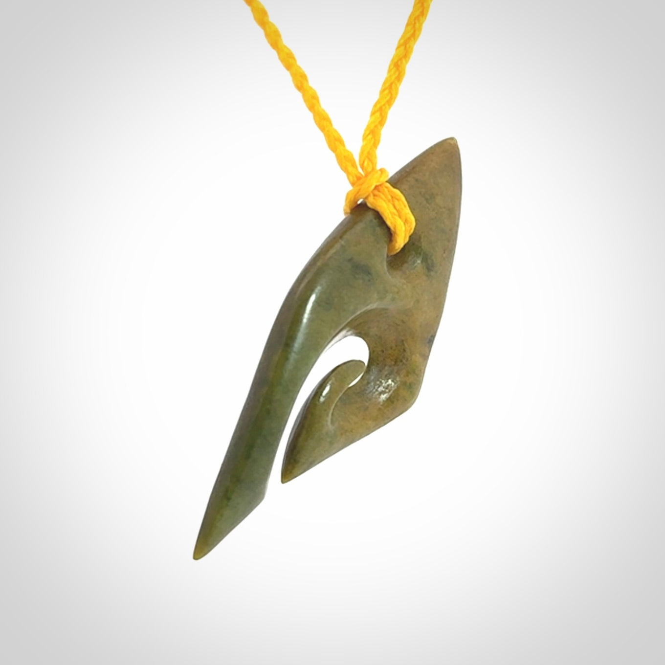 This photo shows a contemporary koru pendant carved into New Zealand Flower Jade. We have added a yellow adjustable cord. This is a fantastic work of art, we have one only.