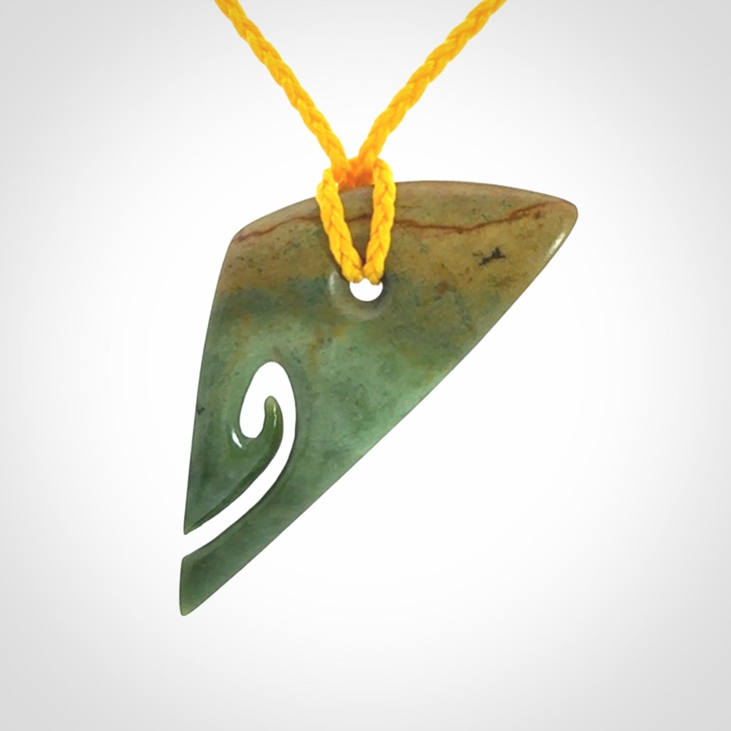 This photo shows a contemporary koru pendant carved into New Zealand Flower Jade. We have added a yellow adjustable cord. This is a fantastic work of art, we have one only.