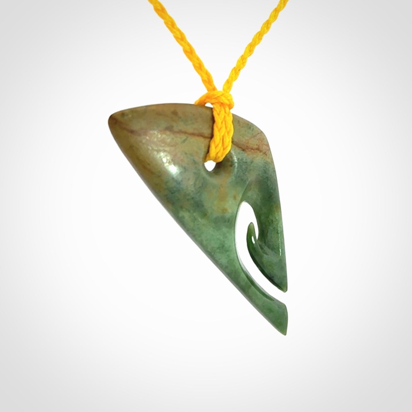 This photo shows a contemporary koru pendant carved into New Zealand Flower Jade. We have added a yellow adjustable cord. This is a fantastic work of art, we have one only.
