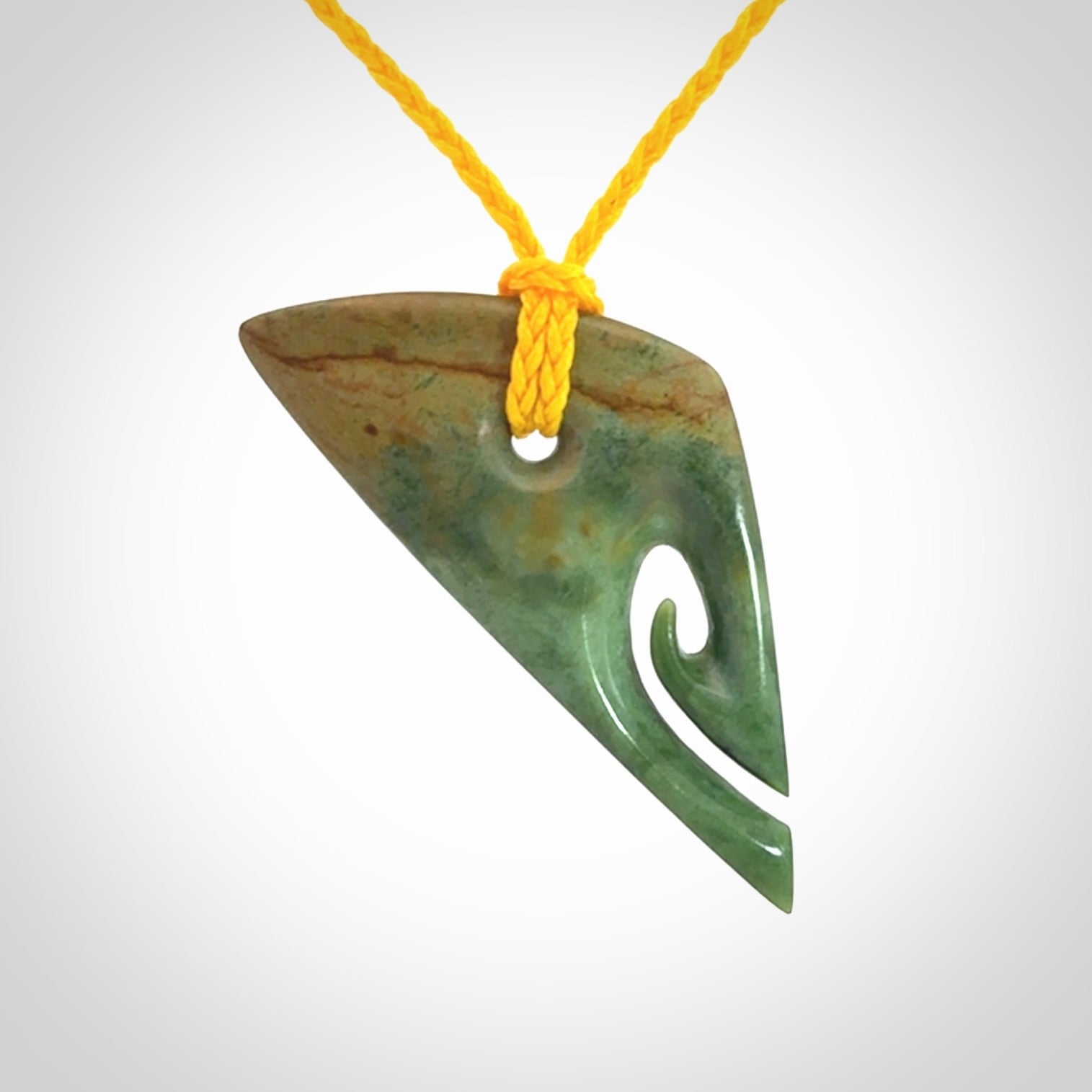 This photo shows a contemporary koru pendant carved into New Zealand Flower Jade. We have added a yellow adjustable cord. This is a fantastic work of art, we have one only.