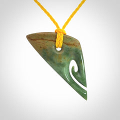 This photo shows a contemporary koru pendant carved into New Zealand Flower Jade. We have added a yellow adjustable cord. This is a fantastic work of art, we have one only.