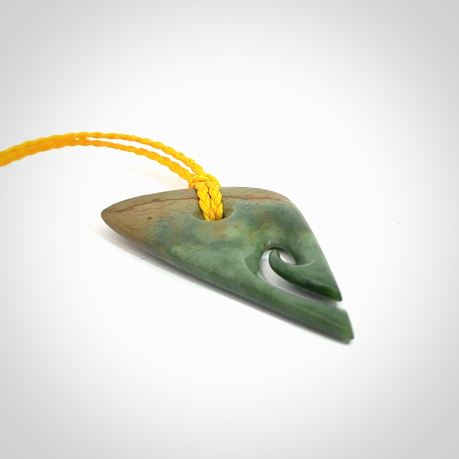 This photo shows a contemporary koru pendant carved into New Zealand Flower Jade. We have added a yellow adjustable cord. This is a fantastic work of art, we have one only.