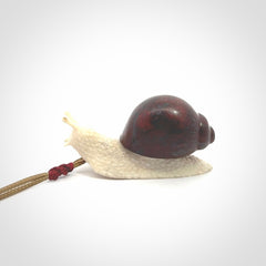 Snail design pendant carved in red jasper with bone. Real jasper and bone jewellery for sale online with NZ Pacific.