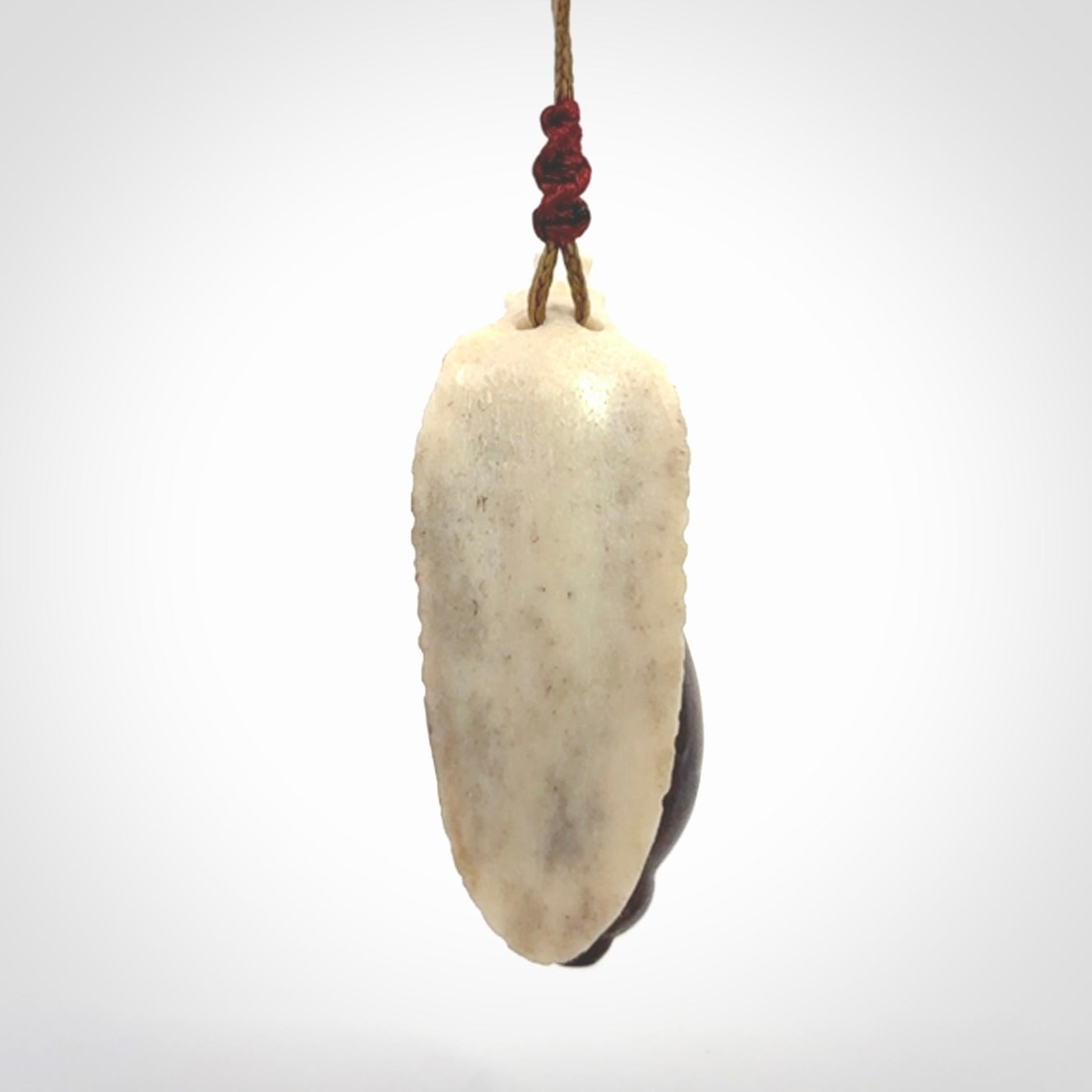 Snail design pendant carved in red jasper with bone. Real jasper and bone jewellery for sale online with NZ Pacific.
