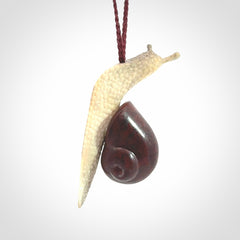 Snail design pendant carved in red jasper with deer antler. Real jasper and bone jewellery for sale online with NZ Pacific.