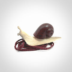 Snail design pendant carved in red jasper with deer antler. Real jasper and bone jewellery for sale online with NZ Pacific.