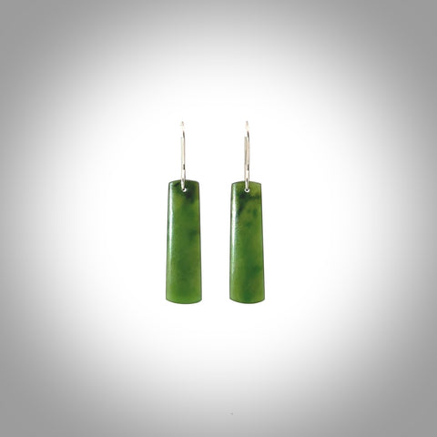 These are stunning medium-large drop shaped jade earrings carved in New Zealand by Darren Hill. It is carved from a semi-translucent light green piece of New Zealand Jade and with Sterling Silver hooks.