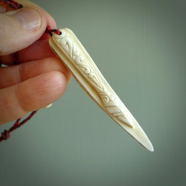 This is a hand carved deer antler taiaha pendant. It is made from deer antler, bone. This is a large sized necklace and is a very unique, one only, pendant that is a wonderful piece. Hand carved deer antler taiaha necklace for men and women.
