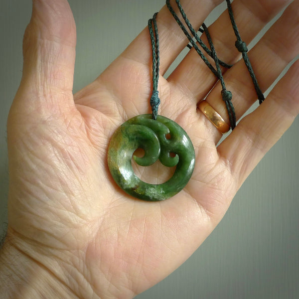 This pendant is a complex koru design. Carved in gorgeous New Zealand jade it is a medium sized pendant that can be worn by anyone. Hand made in New Zealand by NZ Pacific.