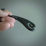 A hand carved large sized drop pendant with a koru carved into the front face. This is a piece of genuine jade jewellery, hand carved by Ric Moor. He has used New Zealand jade and has utilised his experience and carving skill to highlight the natural beauty of the stone. Delivered worldwide, postage is included in the price.