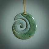 A hand carved koru with face pendant from New Zealand Pounamu, Jade. The cord is Tan and is adjustable. A large hand made Koru necklace by New Zealand artist Kerry Thompson.