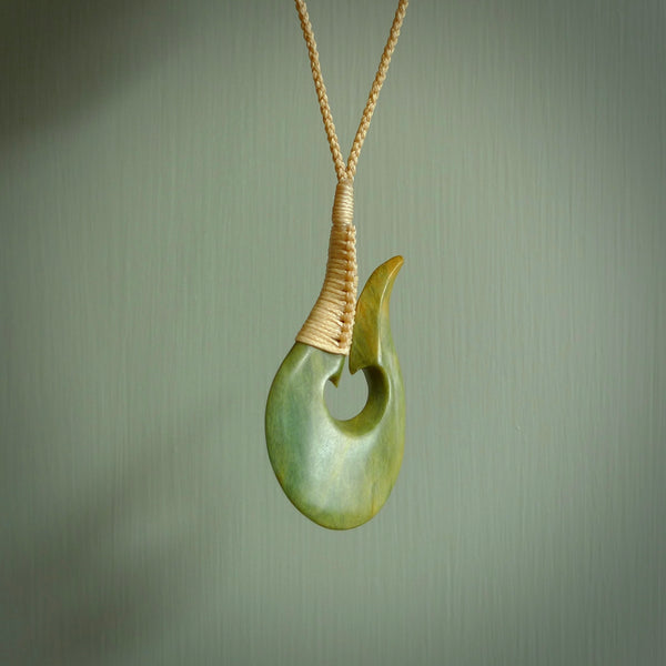 This matau, is carved from a very striking New Zealand jade. It is both intricate and simple in design - it has hidden folds and smooth curves. A piece to be worn or displayed - the carving and the jade are both magnificent. Hand made by Donna Summers.