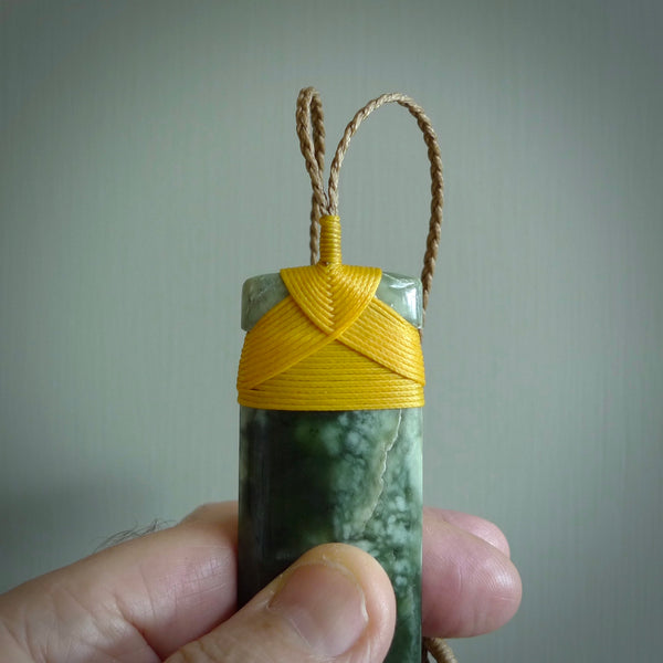 A large and beautiful hand carved toki pendant. This piece is carved from New Zealand flower jade by NZ Pacific. This is a wonderful large toki bound with a tan cord and a traditional lashing. A beautiful, traditional toki for sale online.