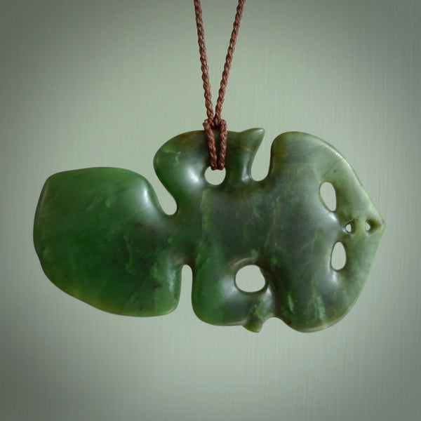 This is a large sized tiki - carved from gorgeous Marsden jade with Pāua Shell eyes. The craftsmanship is superb, this piece is as well carved as any we have seen. We have plaited an adjustable brown cord for this piece. 