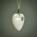 HAND CARVED HEART PENDANT. CARVED FROM BONE. PAUA HEART INSERT. HAND MADE BY NZ PACIFIC. HANDMADE JEWELLERY FOR SALE ONLINE.