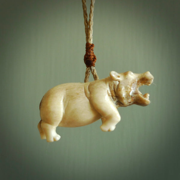 Hand carved deer antler hippo pendant. Hand carved by NZ Pacific. Free postage worldwide. Hand made hippopotamus necklace from deer antler. Ocean themed necklace for men and women. Delivered on an adjustable cord in a woven kete pouch.
