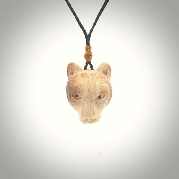 This pendant is a hand carved puma. We've carved this from a lovely piece of woolly mammoth tusk and we provide it with a hand plaited cord. Shipping is free worldwide.