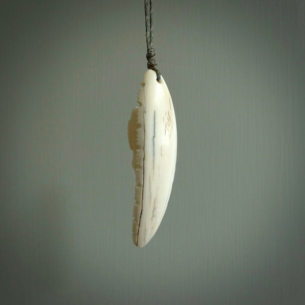 This is a hand carved bone contemporary warthog tusk pendant. Yuri Terenyi has carved this from warthog tusk. It is a delightful, large and artistic piece of jewellery. One only necklace.