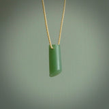This picture shows a small hand carved jade drop pendant by Ric Moor. The jade is a wonderful light, semi-translucent, green. It is suspended from a beige adjustable cord. Delivery is free worldwide.