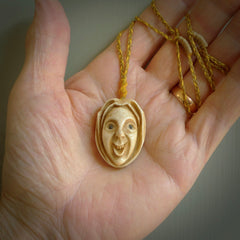 Hand carved incredible stained bone gargoyle face carving. A stunning work of art. This pendant was hand carved in bone with buffalo horn inlay for the eyes by Yuri Terenyi. A one off collectors item that has been hand crafted to be worn or displayed.